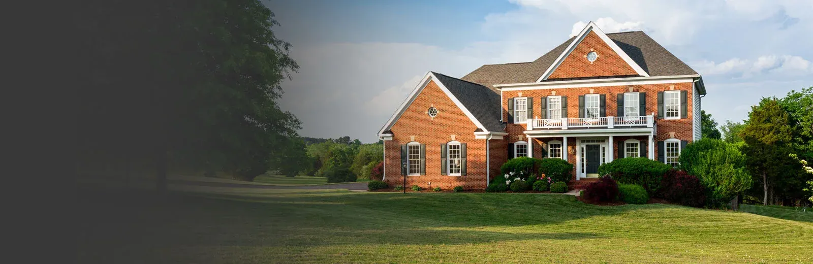 Brick home with green healthy lawn